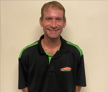 Male Employee of SERVPRO wearing a black short sleeve collared shirt