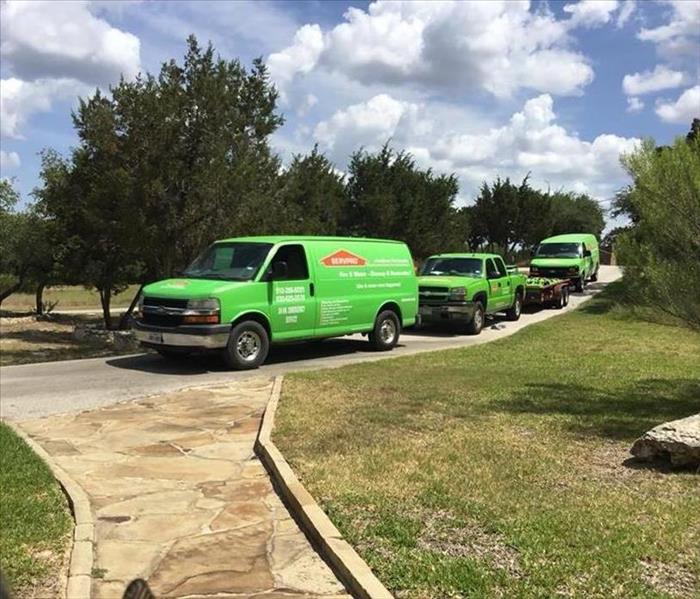 SERVPRO of San Marcos/New Braunfels vehicles rolling up a drive way to help a resident with water damage.